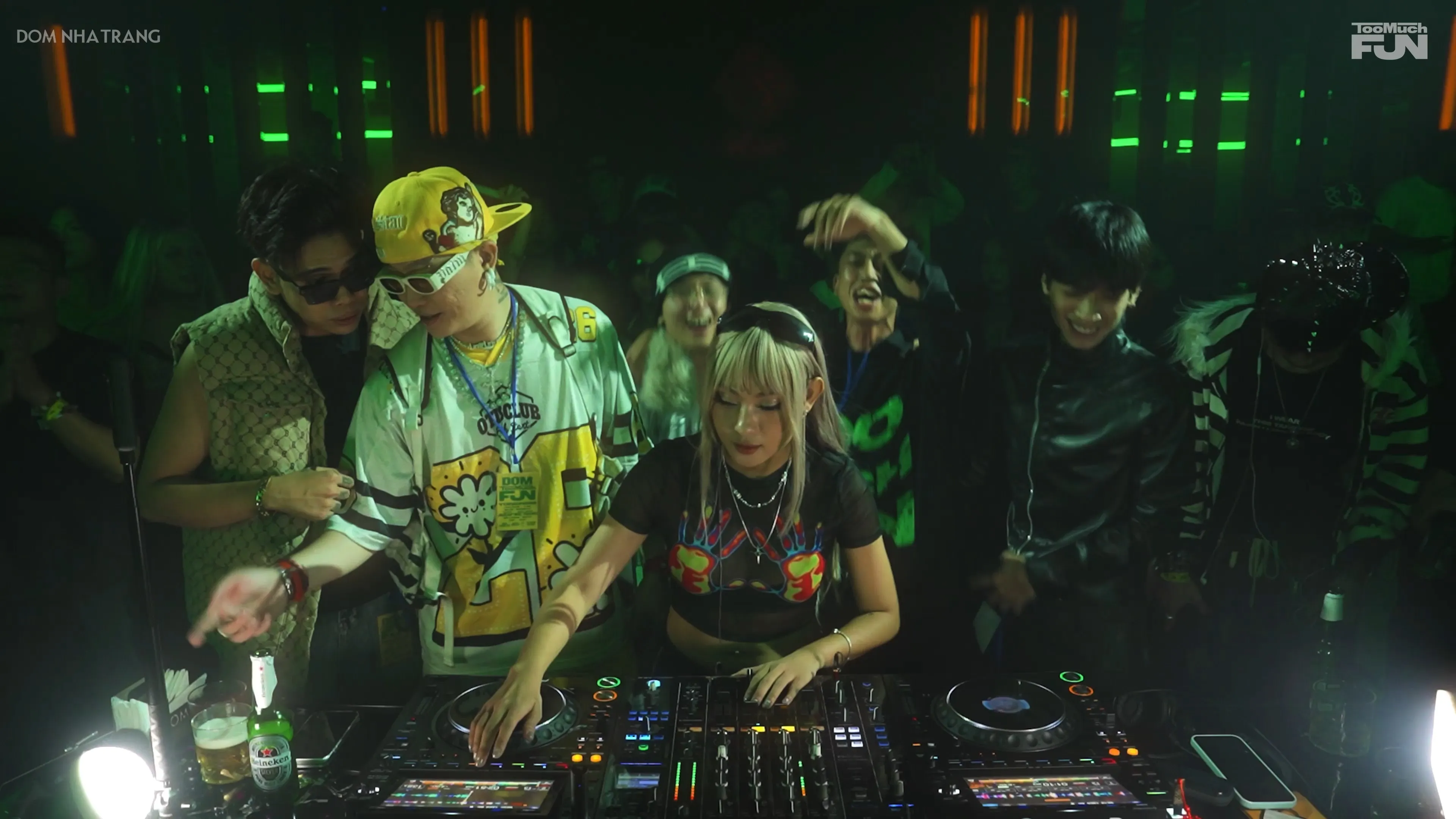 A guest DJ and crew performing under green lights at DOM Nha Trang